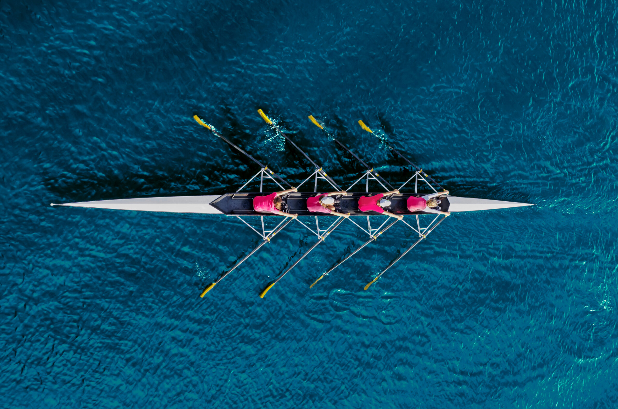 Women's,Rowing,Team,On,Blue,Water,,Top,View